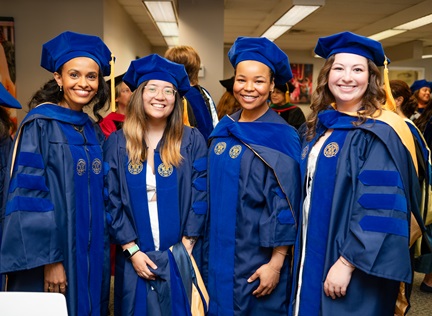 Group of four Dornsife doctoral students at 2025 commencement